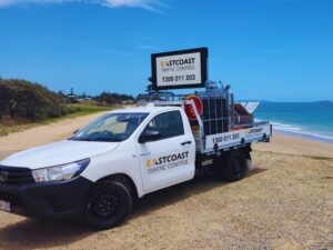 A Toyota Hilux Workmate in an ECTC depot with traffic control signage loaded in the back