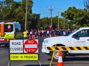 Traffic controllers managing safe road closures for ANZAC Day parades in regional Queensland